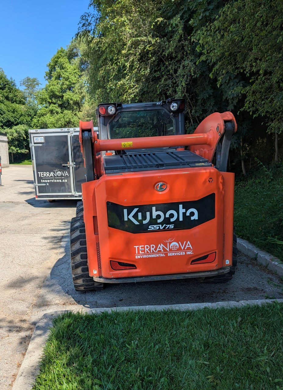 Terra Nova Kubota skid steer and enclosed trailer on a drum removal job