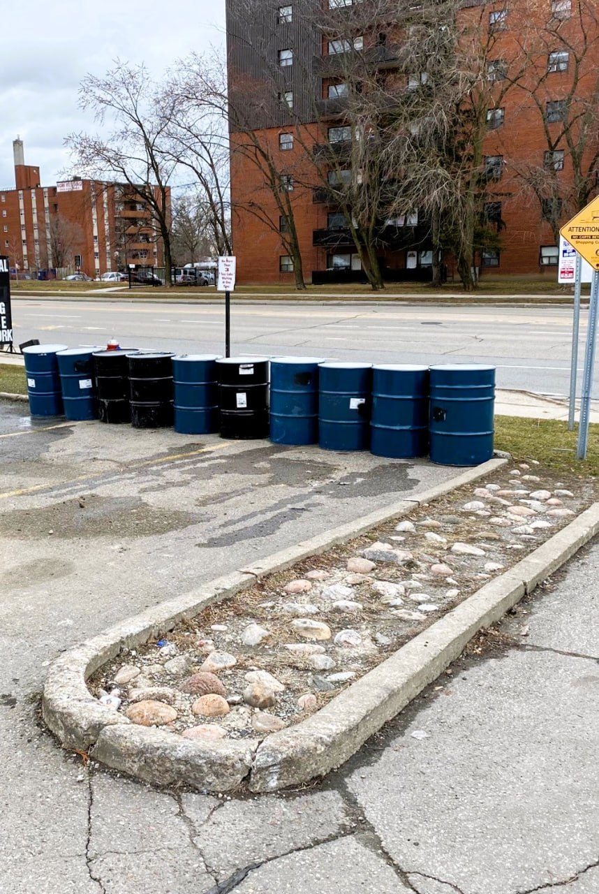 Row of drums removed from a parking-lot site