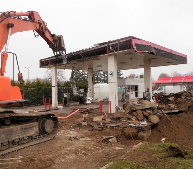 Terra Nova excavator pulling down a gas station canopy